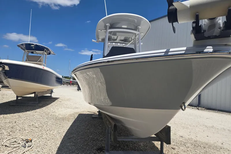 Slide: The Image of 2022 Sportsman Masters 227 Bay Boat displayed outdoors on gravel lot. - 16