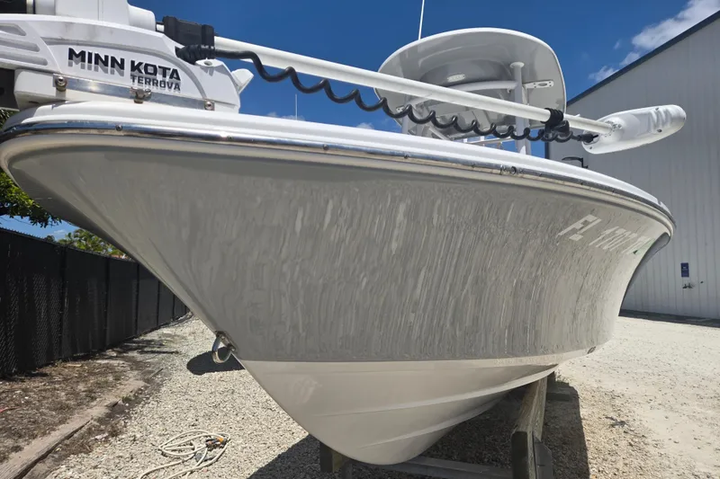 Slide: The Image of 2022 Sportsman Masters 227 Bay Boat with Minn Kota Terrova motor, docked outdoors. - 18