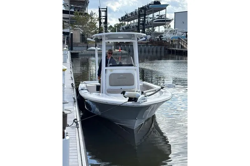 Slide: The Image of 2022 Sportsman Masters 227 Bay Boat docked at marina, featuring sleek design and modern amenities. - 2