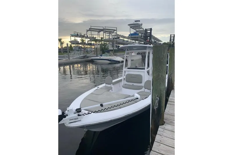 Slide: The Image of 2022 Sportsman Masters 227 Bay Boat docked at marina during sunset. - 4
