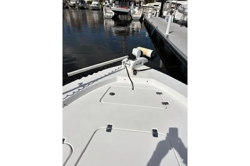 Slide: The Image of 2022 Sportsman Masters 227 Bay Boat docked at marina, bow view. - 8
