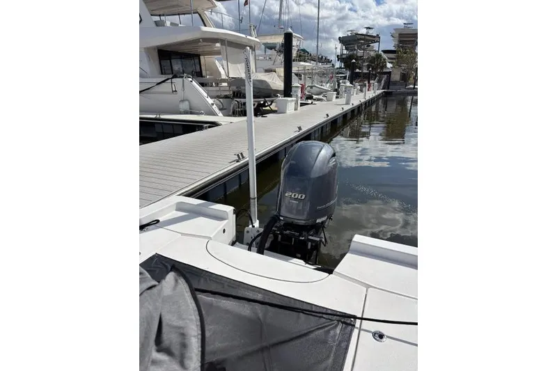 Slide: The Image of 2022 Sportsman Masters 227 Bay Boat docked with 200 HP outboard motor. - 9