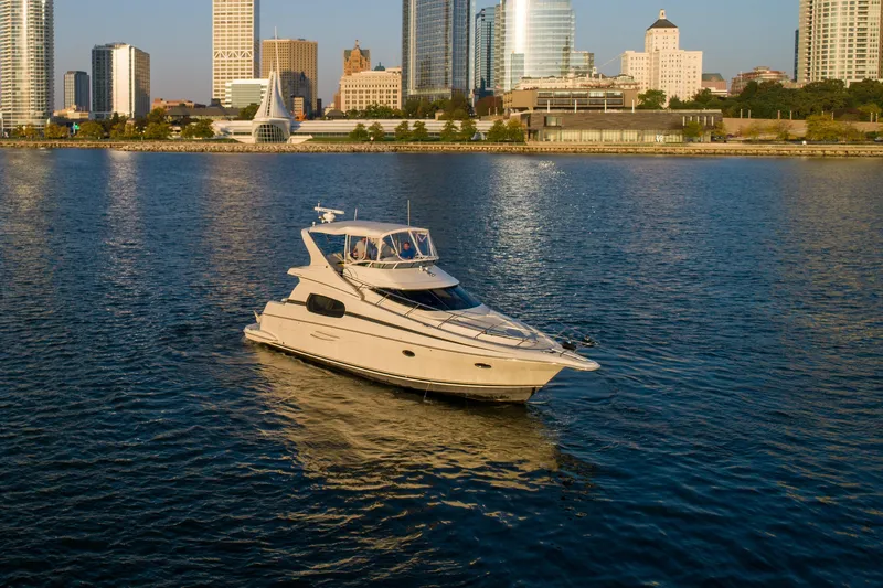 Slide: The Image of 2003 Silverton 410 Sport Bridge yacht on urban waterfront with city skyline. - 20