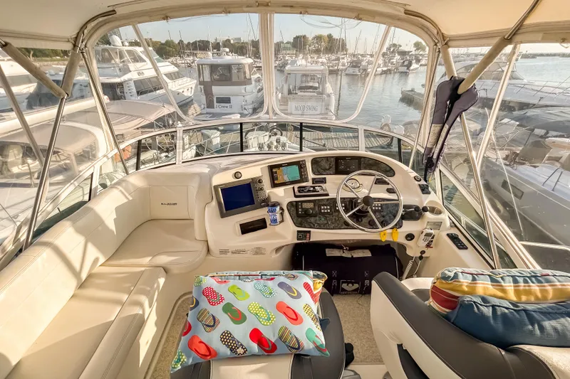 Slide: The Image of Interior view of 2003 Silverton 410 Sport Bridge yacht cockpit at marina. - 28