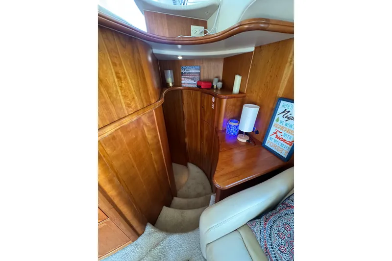 Slide: The Image of Interior of 2003 Silverton 410 Sport Bridge with wooden paneling and cozy decor. - 49