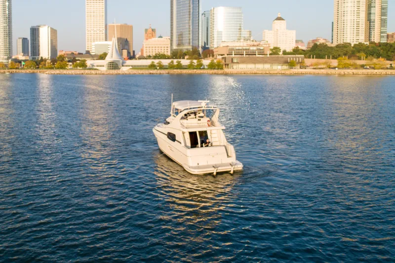 Slide: The Image of 2003 Silverton 410 Sport Bridge yacht cruising near city skyline. - 6