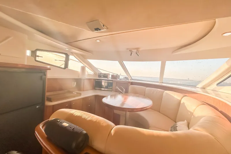 Slide: The Image of Interior of 2003 Silverton 410 Sport Bridge yacht with plush seating and panoramic windows. - 68