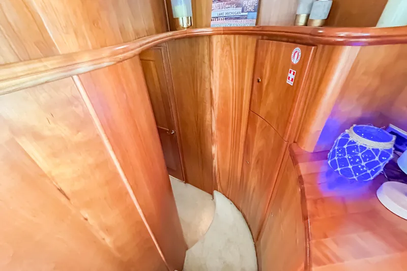 Slide: The Image of Interior of 2003 Silverton 410 Sport Bridge with wooden paneling and nautical decor. - 71