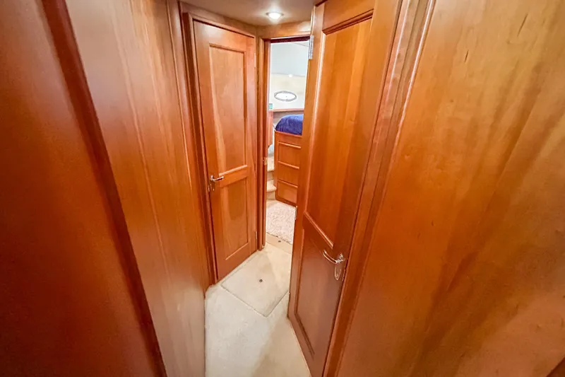 Slide: The Image of Interior hallway of 2003 Silverton 410 Sport Bridge with wooden doors and carpeted floor. - 72