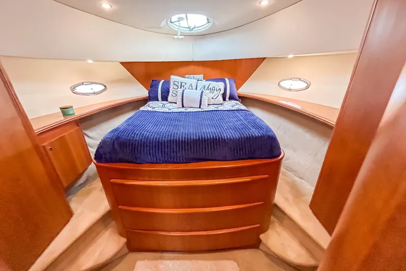 Slide: The Image of Luxurious cabin interior of a 2003 Silverton 410 Sport Bridge yacht with cozy bedding. - 74