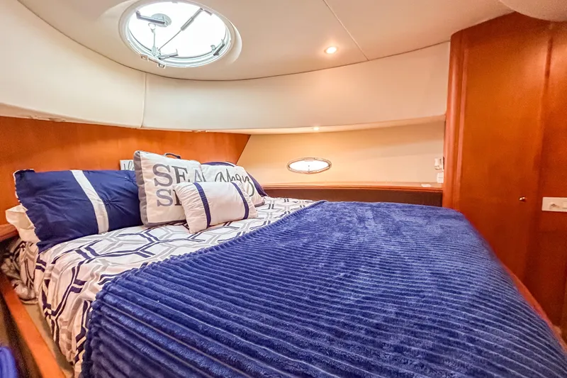 Slide: The Image of Luxurious cabin interior of 2003 Silverton 410 Sport Bridge with cozy bedding. - 77