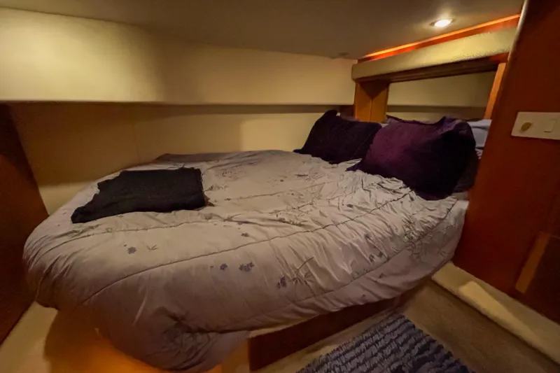 Slide: The Image of Cozy bedroom interior of 2003 Silverton 410 Sport Bridge yacht with plush bedding. - 79