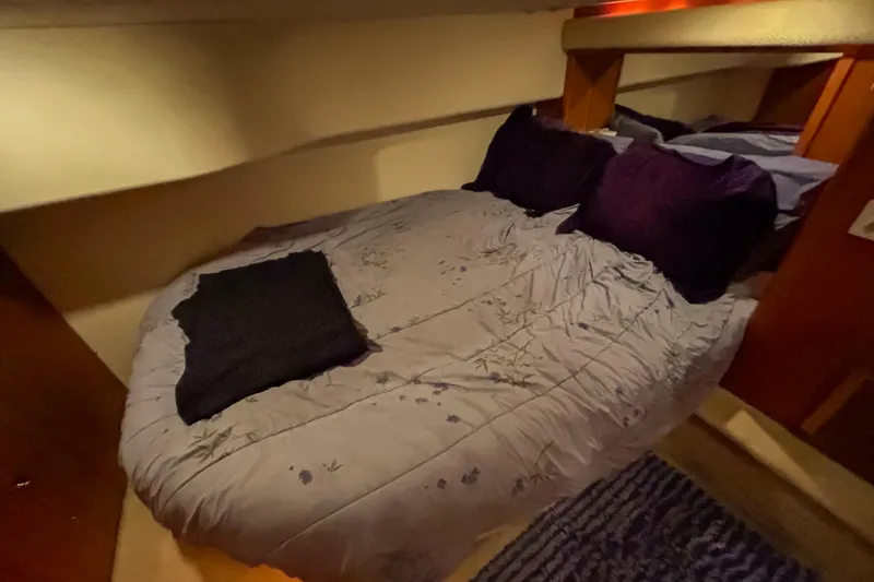 Slide: The Image of Cozy bedroom in 2003 Silverton 410 Sport Bridge yacht with plush bedding. - 81