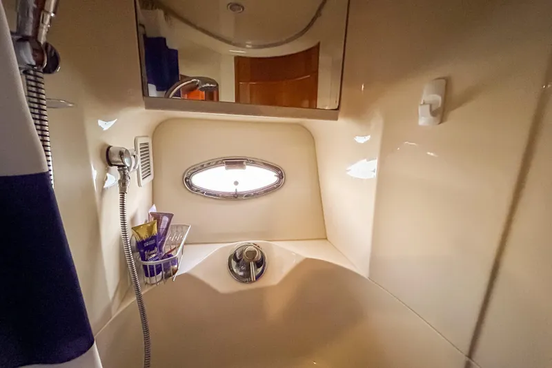 Slide: The Image of Bathroom interior of 2003 Silverton 410 Sport Bridge yacht with shower and porthole. - 82