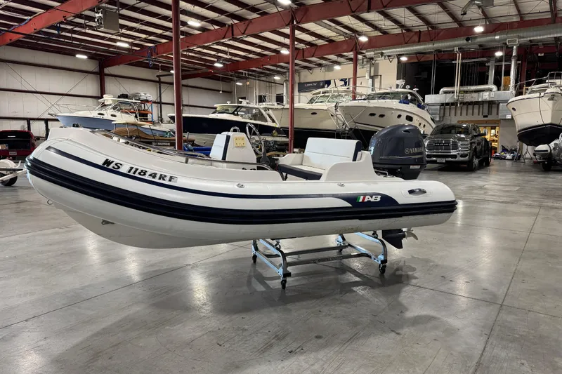 Slide: The Image of 2018 AB Inflatables Nautilus 12 DLX boat in a spacious indoor showroom. - 2