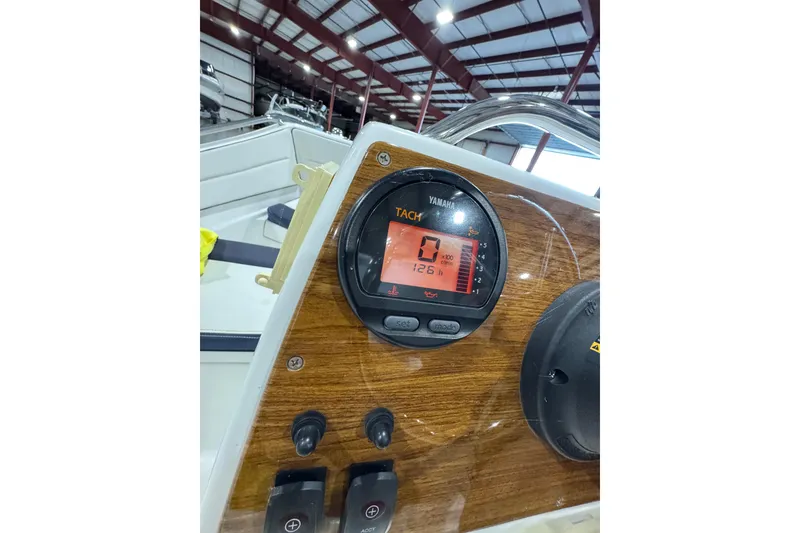 Slide: The Image of Yamaha tachometer on 2018 AB Inflatables Nautilus 12 DLX dashboard in a boat warehouse. - 21