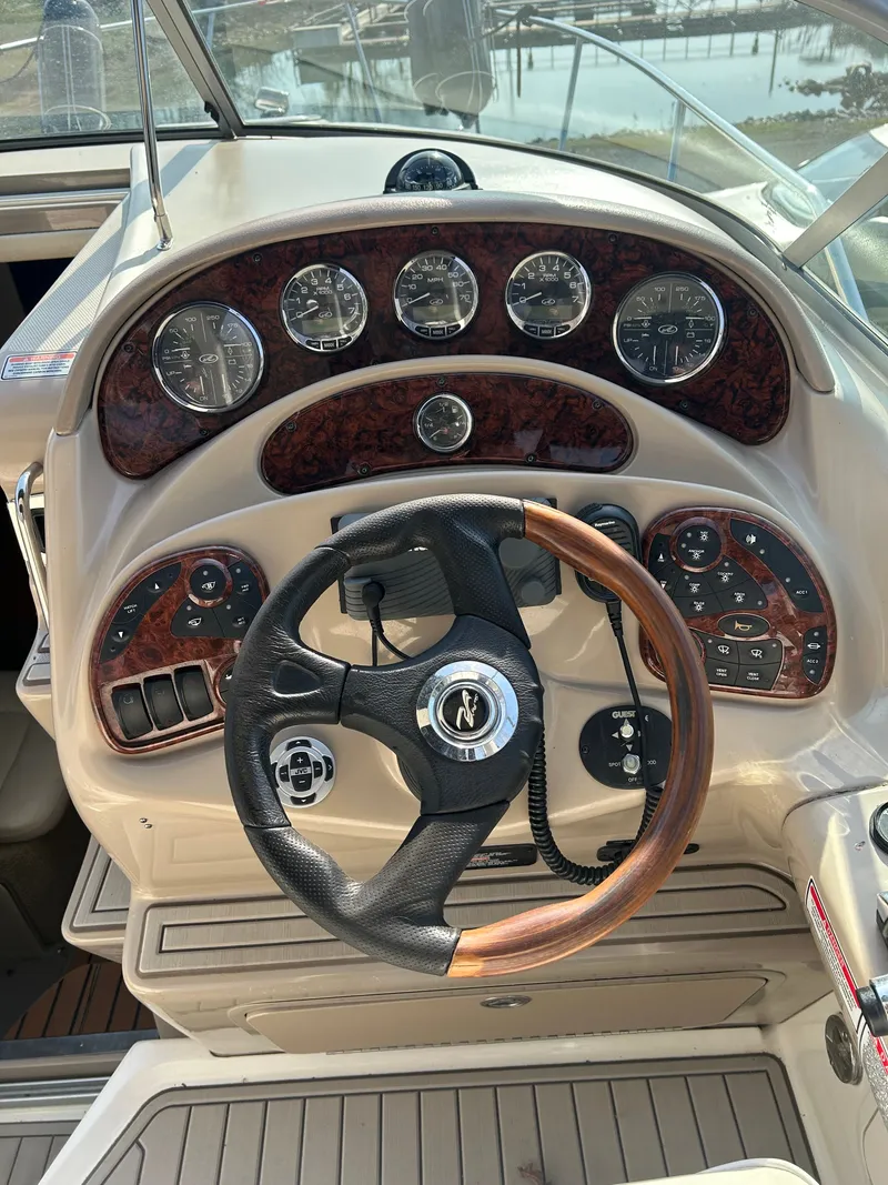 Slide: The Image of 2005 Sea Ray Sundancer 280 helm with wood-accented steering wheel. - 13