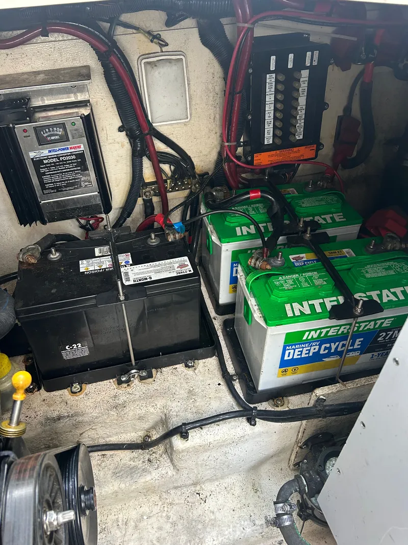 Slide: The Image of Batteries and wiring in the engine compartment of a 2005 Sea Ray Sundancer 280. - 22