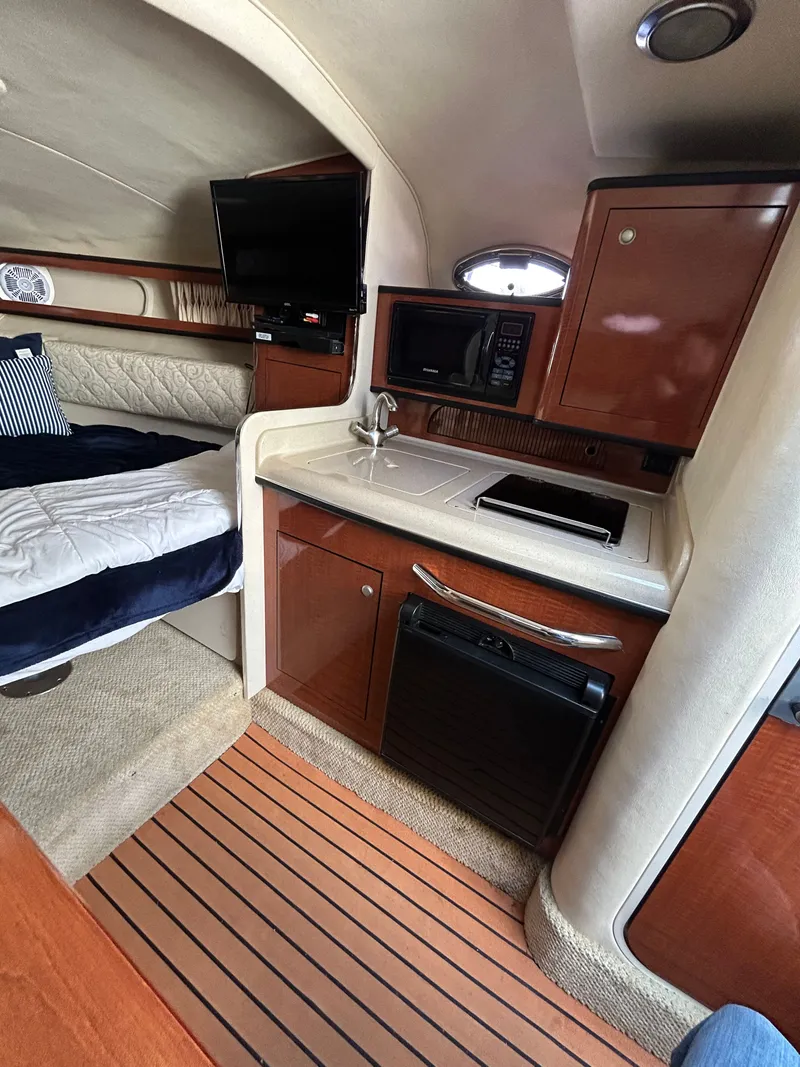 Slide: The Image of Interior of 2005 Sea Ray Sundancer 280 yacht with kitchen and sleeping area. - 7