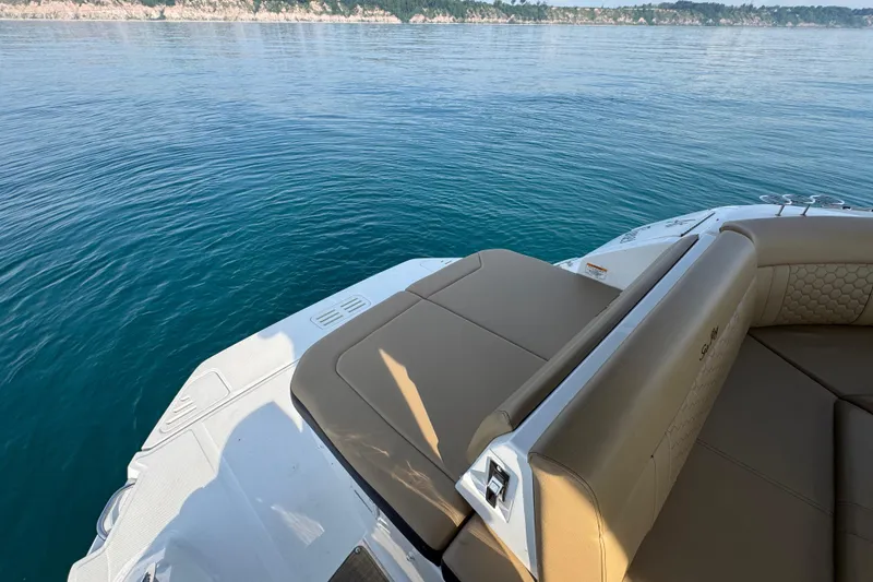 Slide: The Image of 2019 Sea Ray Sundancer 320 boat with tan seating on calm water. - 14