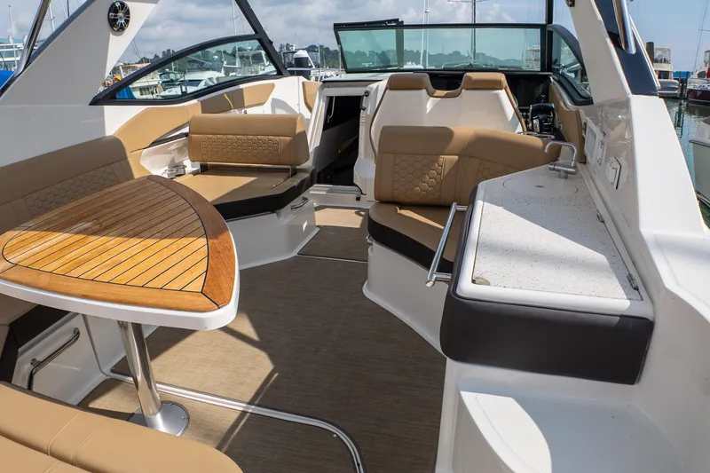 Slide: The Image of Luxurious interior of 2019 Sea Ray Sundancer 320 yacht with elegant seating and wooden table. - 16