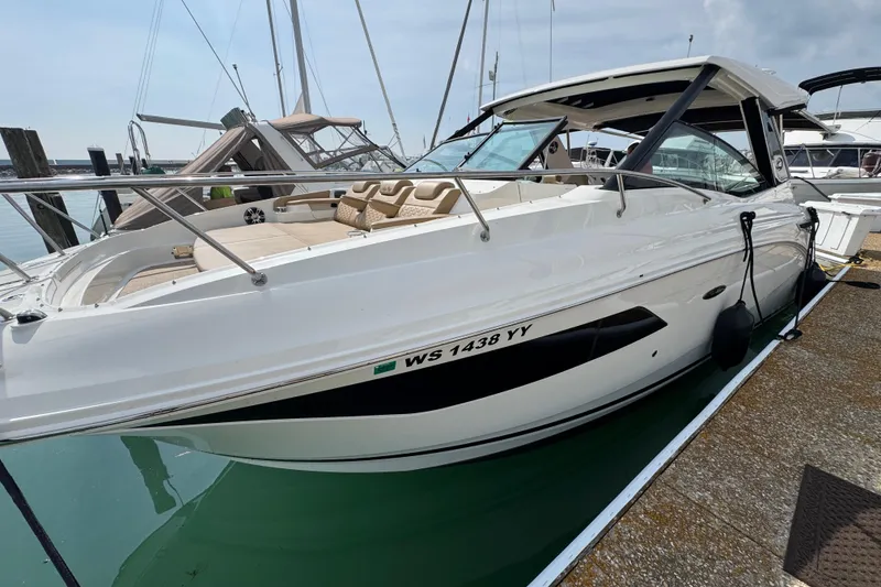Slide: The Image of 2019 Sea Ray Sundancer 320 boat docked at marina, sleek white design. - 2