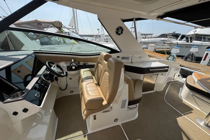 Slide: The Image of Interior of a 2019 Sea Ray Sundancer 320 yacht with luxurious seating and helm. - 21