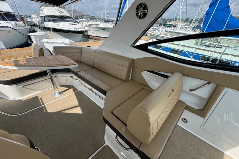 Slide: The Image of Luxurious interior of 2019 Sea Ray Sundancer 320 yacht with elegant seating and table. - 24