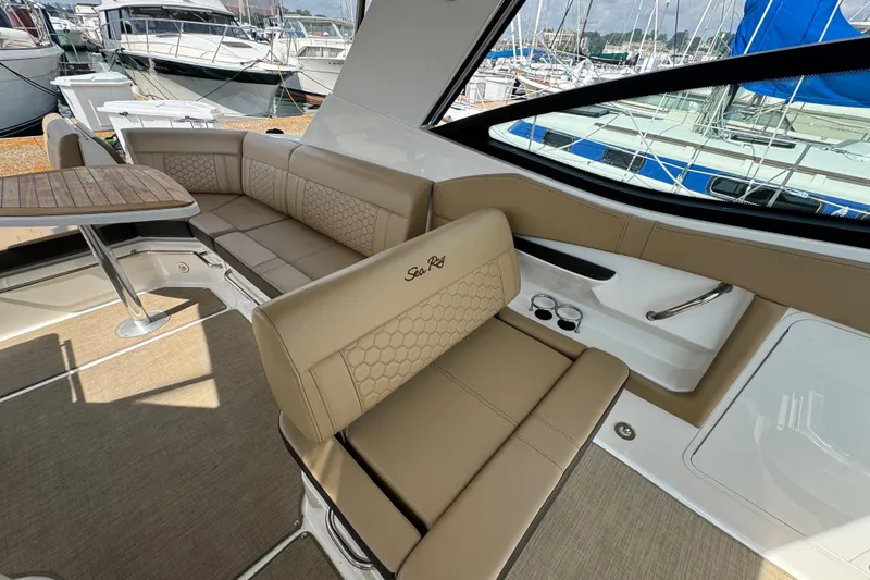 Slide: The Image of Luxurious interior of 2019 Sea Ray Sundancer 320 yacht with beige seating and wooden table. - 25