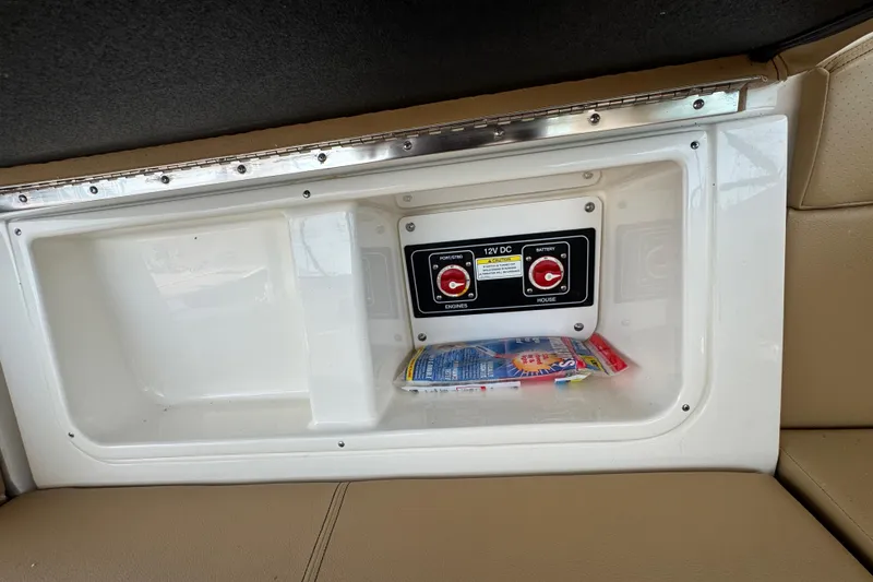Slide: The Image of 2019 Sea Ray Sundancer 320 interior with 12V DC control panel and storage compartment. - 26