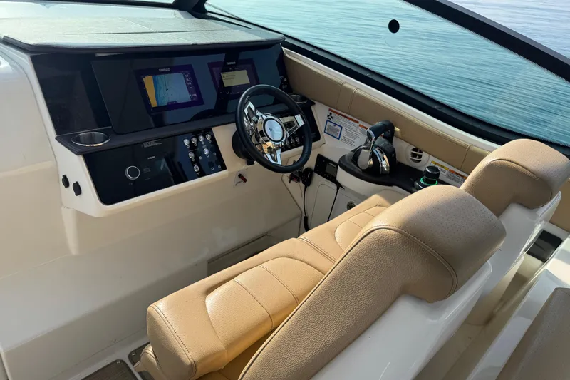 Slide: The Image of 2019 Sea Ray Sundancer 320 helm with modern controls and navigation displays. - 27