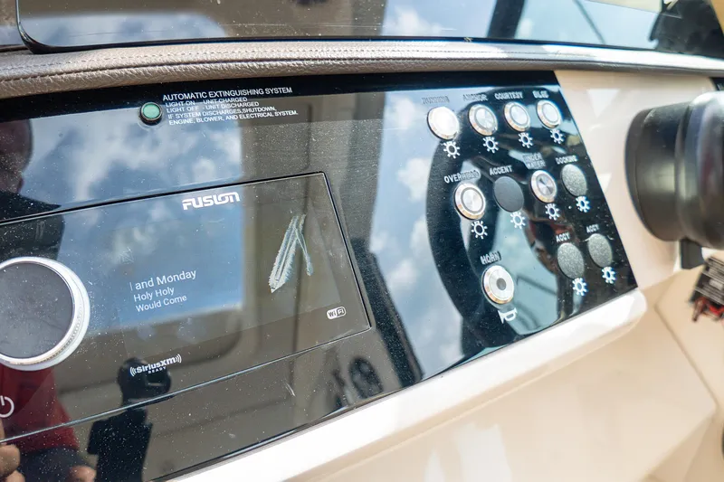 Slide: The Image of Control panel of a 2019 Sea Ray Sundancer 320 boat with Fusion audio system. - 28