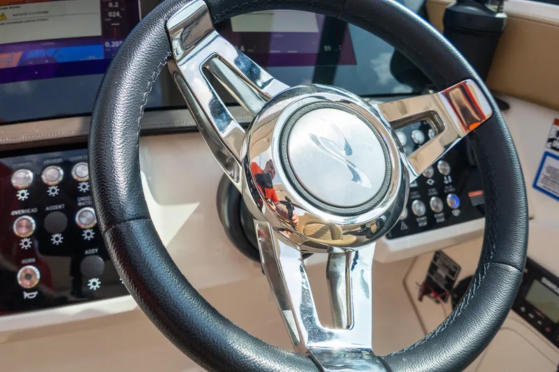 Slide: The Image of Steering wheel of a 2019 Sea Ray Sundancer 320 boat with control panel. - 29