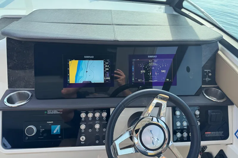 Slide: The Image of 2019 Sea Ray Sundancer 320 helm with Simrad navigation displays and modern controls. - 31