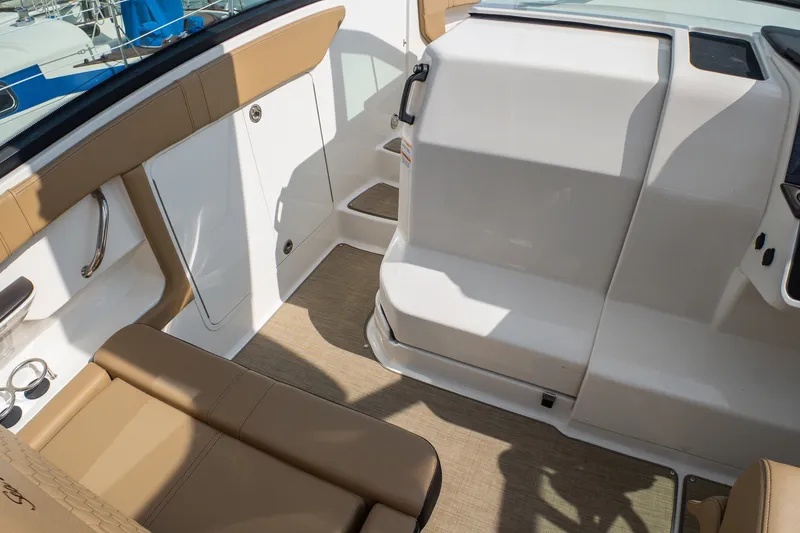Slide: The Image of Interior view of 2019 Sea Ray Sundancer 320 boat with tan seating and white surfaces. - 36
