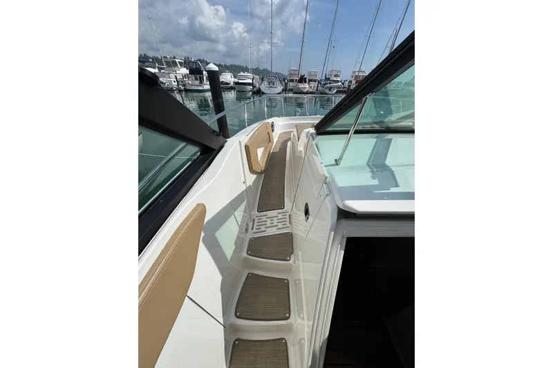 Slide: The Image of 2019 Sea Ray Sundancer 320 yacht docked, showcasing sleek deck design and marina view. - 37