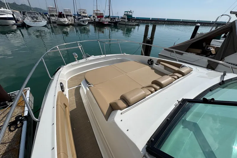 Slide: The Image of 2019 Sea Ray Sundancer 320 yacht docked at marina, featuring spacious sunbathing area. - 38