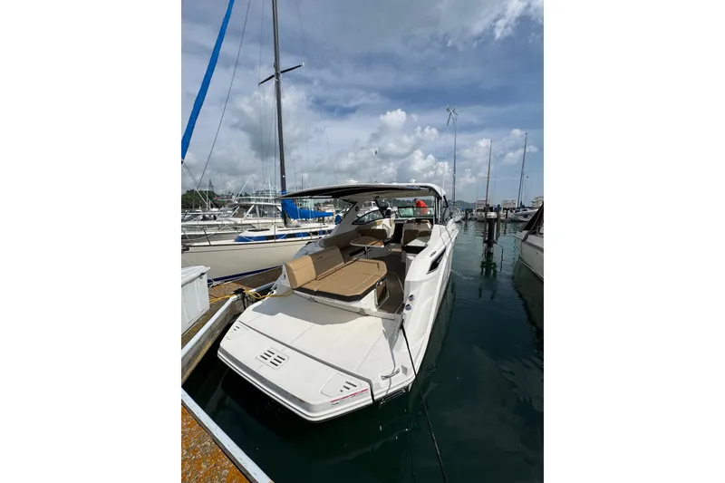 Slide: The Image of 2019 Sea Ray Sundancer 320 docked at marina under cloudy sky. - 4