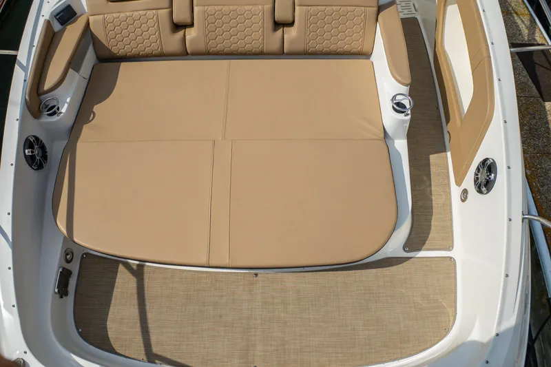 Slide: The Image of 2019 Sea Ray Sundancer 320 boat interior with beige cushioned seating and speakers. - 40