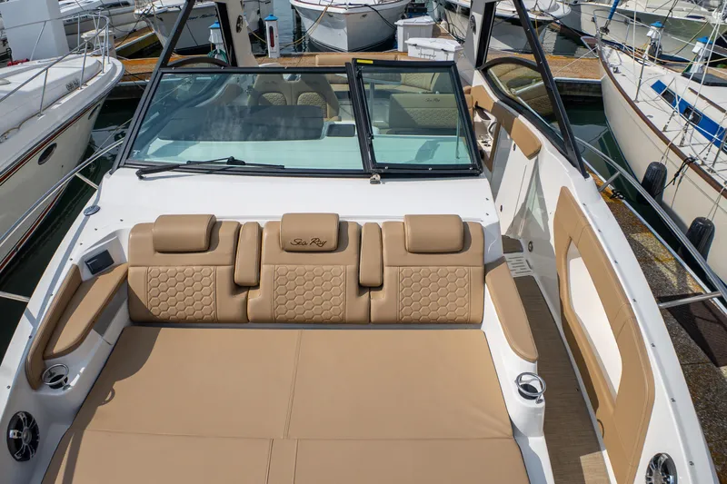 Slide: The Image of 2019 Sea Ray Sundancer 320 boat with luxurious tan seating at a marina. - 41