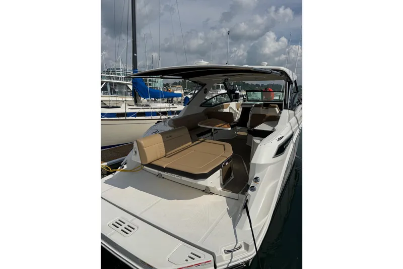 Slide: The Image of 2019 Sea Ray Sundancer 320 yacht docked, featuring spacious seating and sleek design. - 5