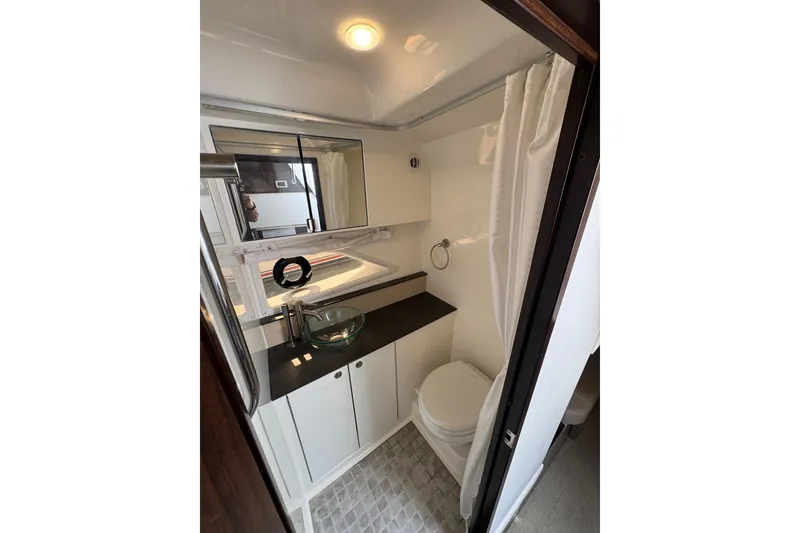 Slide: The Image of 2019 Sea Ray Sundancer 320 bathroom with modern fixtures and compact design. - 55