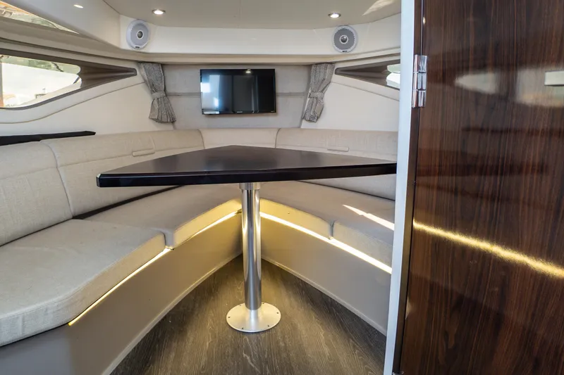 Slide: The Image of Interior of 2019 Sea Ray Sundancer 320 with cozy seating and modern table. - 58