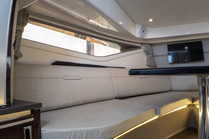 Slide: The Image of Interior of 2019 Sea Ray Sundancer 320 yacht with modern seating and a mounted TV. - 59
