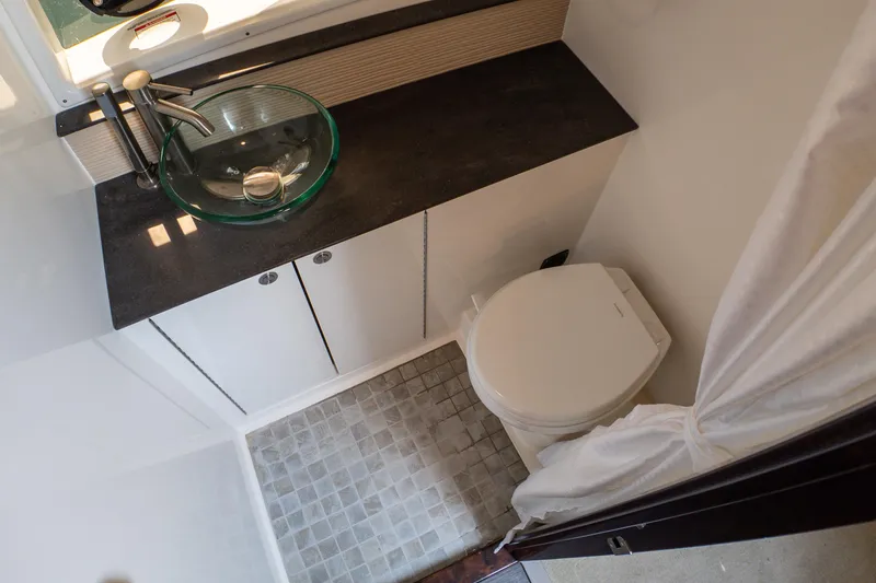 Slide: The Image of 2019 Sea Ray Sundancer 320 bathroom with glass sink and modern fixtures. - 61