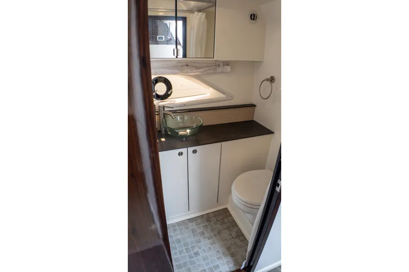 Slide: The Image of 2019 Sea Ray Sundancer 320 bathroom with modern fixtures and glass sink. - 63