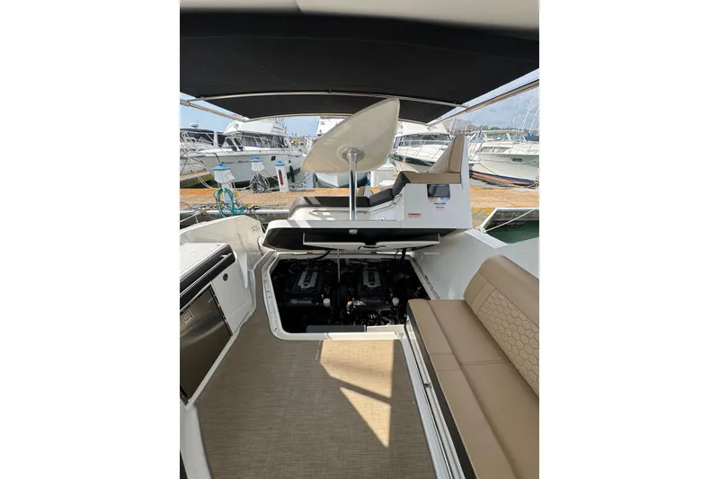 Slide: The Image of 2019 Sea Ray Sundancer 320 interior with open engine compartment, docked at marina. - 64
