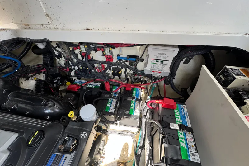 Slide: The Image of Engine compartment of a 2019 Sea Ray Sundancer 320 with batteries and wiring. - 66