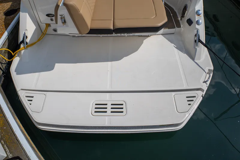 Slide: The Image of 2019 Sea Ray Sundancer 320 swim platform with tan seating, docked in water. - 7