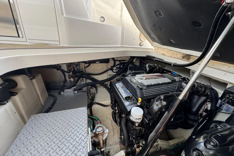 Slide: The Image of Engine compartment of a 2019 Sea Ray Sundancer 320 boat, showcasing detailed mechanical components. - 74